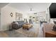Bright living room featuring a gray sofa, a large ottoman, and access to the backyard through sliding glass doors at 743 43Rd Ne Ave, St Petersburg, FL 33703