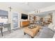 Comfortable living room featuring a TV, a view to the dining room, and a blue door to the backyard at 743 43Rd Ne Ave, St Petersburg, FL 33703