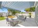 Beautiful patio with blue and white awning, seating, manicured yard and landscaping at 743 43Rd Ne Ave, St Petersburg, FL 33703