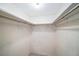 Walk-in closet features shelving, rod, and neutral finishes to maximize storage at 801 83Rd N Ave # 107, St Petersburg, FL 33702