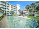 Exterior of the complex with a shuffleboard court in the courtyard seating area at 801 83Rd N Ave # 107, St Petersburg, FL 33702