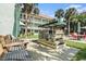 Exterior features outdoor seating with a swing in the lush landscaped courtyard at 801 83Rd N Ave # 107, St Petersburg, FL 33702