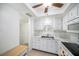 Clean white kitchen with tray ceiling, window, and stainless steel appliances at 801 83Rd N Ave # 107, St Petersburg, FL 33702