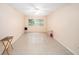 Open living room with tile flooring, ceiling fan, and view of window with blinds at 801 83Rd N Ave # 107, St Petersburg, FL 33702
