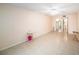 Living room with tile flooring, ceiling fan, small tables and entrance to bathroom at 801 83Rd N Ave # 107, St Petersburg, FL 33702