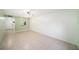 Spacious living room with tile flooring and a view into the hall and entry door at 801 83Rd N Ave # 107, St Petersburg, FL 33702