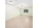 Bright empty living room featuring neutral tile floor and a large window at 801 83Rd N Ave # 107, St Petersburg, FL 33702