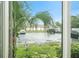 View of parking lot and landscaping from window offers a glimpse of the exterior at 801 83Rd N Ave # 107, St Petersburg, FL 33702