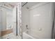 Hall bathroom features a clean white tub with a shower and tiled walls at 8980 Antigua Dr, Seminole, FL 33777