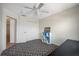 A tidy bedroom with an overhead ceiling fan, a closet and a wall shelf at 8980 Antigua Dr, Seminole, FL 33777