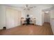 Spacious bedroom features a ceiling fan, a built-in desk with storage, and wood floors at 8980 Antigua Dr, Seminole, FL 33777