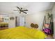 Bright bedroom with ceiling fan, warm hardwood floors, and ensuite bathroom access at 8980 Antigua Dr, Seminole, FL 33777