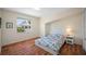 Comfortable bedroom with hardwood floors and a large window for natural light at 8980 Antigua Dr, Seminole, FL 33777