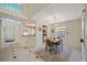 Bright dining area with tile floors, decorative rug, and eat-in kitchen view provides an inviting space for Gathering meals at 8980 Antigua Dr, Seminole, FL 33777