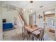 Open-concept living room and dining area with a staircase, creating a seamless flow for entertaining and everyday living at 8980 Antigua Dr, Seminole, FL 33777