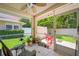 Relaxing screened patio with ceiling fan and seating area, perfect for enjoying the outdoors and lush backyard views at 8980 Antigua Dr, Seminole, FL 33777