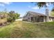 Well-maintained backyard featuring a screened enclosure and partial fencing at 9047 Quail Creek Dr, Tampa, FL 33647