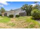 A view of the home's backyard and partial screened lanai at 9047 Quail Creek Dr, Tampa, FL 33647