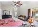 Spacious bedroom features vaulted ceiling, ceiling fan, and sliding glass door to the patio at 9047 Quail Creek Dr, Tampa, FL 33647