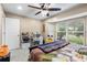 Bright bedroom with a large window, desk, and fan that provides an area for relaxation and productivity at 9047 Quail Creek Dr, Tampa, FL 33647