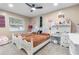 Cozy bedroom featuring two beds, white furniture and a ceiling fan at 9047 Quail Creek Dr, Tampa, FL 33647