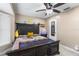 Cozy bedroom featuring dark wood furniture, neutral walls, and a ceiling fan for added comfort at 9047 Quail Creek Dr, Tampa, FL 33647
