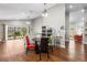 Dining area featuring wood floors and a round table with colorful chairs at 9047 Quail Creek Dr, Tampa, FL 33647