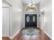 A beautiful entryway with a chandelier, wood floors, and a decorative rug at 9047 Quail Creek Dr, Tampa, FL 33647