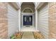 A close view of the front door with blue double doors and decorative windows at 9047 Quail Creek Dr, Tampa, FL 33647