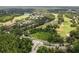 Aerial view of lush golf course winding through a residential community, surrounded by mature trees and landscaping at 9047 Quail Creek Dr, Tampa, FL 33647