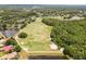 Aerial view of a well-maintained golf course surrounded by water, trees, and a residential neighborhood at 9047 Quail Creek Dr, Tampa, FL 33647