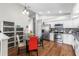 Bright eat-in kitchen featuring stainless appliances, mosaic backsplash, and wooden flooring at 9047 Quail Creek Dr, Tampa, FL 33647