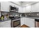 Close up of the kitchen with stainless appliances, including stove, microwave, and dishwasher at 9047 Quail Creek Dr, Tampa, FL 33647