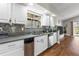 White cabinets and mosaic backsplash complement stainless appliances in this modern kitchen at 9047 Quail Creek Dr, Tampa, FL 33647
