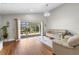 Open living room with sliding glass doors to the lanai and light tan sofas at 9047 Quail Creek Dr, Tampa, FL 33647
