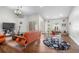 Bright living room with hardwood floors, modern furniture, and sliding glass doors to the outdoors at 9047 Quail Creek Dr, Tampa, FL 33647