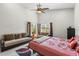 Bright main bedroom featuring high ceilings, carpeting, and a cozy seating area near the windows at 9047 Quail Creek Dr, Tampa, FL 33647