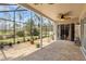 Spacious screened lanai perfect for outdoor relaxation, complemented by a view of the wooded backyard at 9047 Quail Creek Dr, Tampa, FL 33647