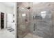 Glass-enclosed shower boasts gray tiling and an open layout, with access to bathroom at 9047 Quail Creek Dr, Tampa, FL 33647