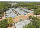 Aerial shot showing a large number of well-maintained tennis courts with green canopies for shade within the community at 9047 Quail Creek Dr, Tampa, FL 33647
