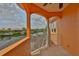 Balcony featuring decorative columns offering waterfront views at 920 Symphony Isles Blvd, Apollo Beach, FL 33572