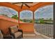 Balcony featuring two chairs, a ceiling fan, and waterfront views at 920 Symphony Isles Blvd, Apollo Beach, FL 33572