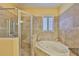Stylish bathroom with a jacuzzi tub, a separate shower, and stone surround at 920 Symphony Isles Blvd, Apollo Beach, FL 33572