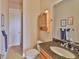 Bathroom features a granite countertop, wooden vanity, and tiled shower at 920 Symphony Isles Blvd, Apollo Beach, FL 33572
