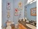 Charming half bathroom with unique decor, granite countertops, and ample storage at 920 Symphony Isles Blvd, Apollo Beach, FL 33572
