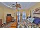 Calming main bedroom with ceiling fan, wooden floors, and comfortable furnishings at 920 Symphony Isles Blvd, Apollo Beach, FL 33572