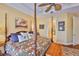 Comfortable bedroom with a unique decorative quilt and a ceiling fan for added comfort at 920 Symphony Isles Blvd, Apollo Beach, FL 33572