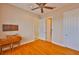 Bedroom featuring a ceiling fan, wood floors, and white painted trim at 920 Symphony Isles Blvd, Apollo Beach, FL 33572