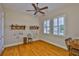 Bright bedroom with hardwood floors, ceiling fan, and windows with plantation shutters at 920 Symphony Isles Blvd, Apollo Beach, FL 33572