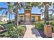 Community clubhouse featuring a welcoming entrance, well-maintained landscaping, and a clear address marker at 920 Symphony Isles Blvd, Apollo Beach, FL 33572
